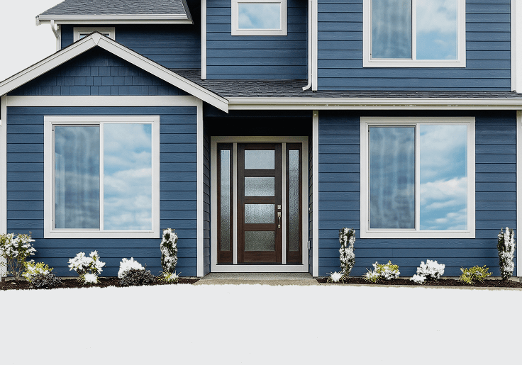 Blue house exterior showcasing energy-efficient windows and a stylish entry door, emphasizing home improvement and curb appeal.